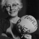 Malvina Reynolds holding a a balloon labeled Flower Power